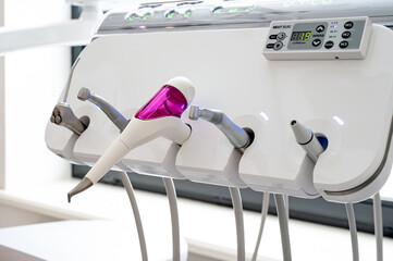 Modern dental equipment in a clinic, featuring a variety of tools, including an air polisher, showcasing advanced technology for dental care