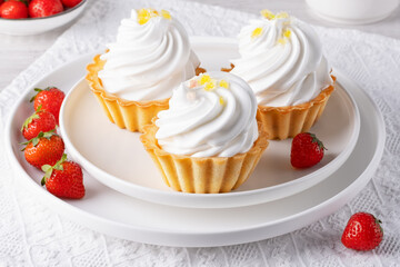 Baskets with protein cream and strawberries on a white table
