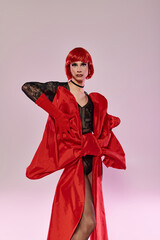 A stunning drag queen showcases boldness in a striking red ensemble.