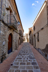 A small street among the old houses of a Guardia Perticara, small town in Basilicata, Italy.
