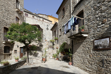 A small street among the old houses of a Guardia Perticara, small town in Basilicata, Italy.