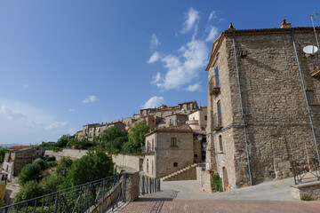 Fototapeta premium A small street among the old houses of a Guardia Perticara, small town in Basilicata, Italy.