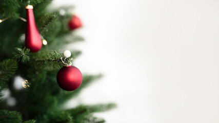 Christmas tree branch with a ball on a light background