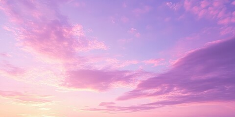 A serene sunset sky filled with soft pink and purple clouds, creating a calm and peaceful atmosphere at dusk.