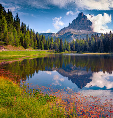 Fototapeta premium Tre Cime di Lavaredo (Drei Zinnen) peak reflected in the calm waters of Antorno lake. Beautiful summer view of Dolomite Alps, Italy, Europe. Travel the world..