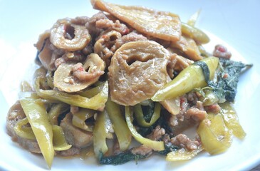 spicy stir fried gluten protein and tofu with basil dressing slice gree chili vegetarian fusion food on plate