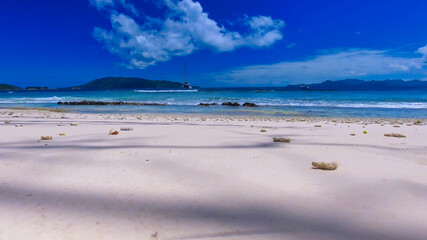 Obraz premium Grand Sister Island close to La Digue, Seychelles. Aerial view of tropical coastline on a sunny day