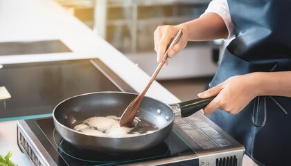 Person cooking in a skillet, focused on the meal preparation.