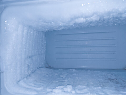 Empty fridge with ice. lce in freezer.