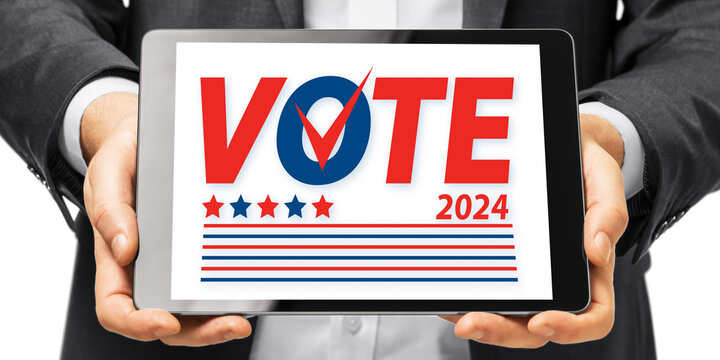 Close up of businessman hands using tablet with 2024 presidential elections. Vote day. November 5. US election banner. - Powered by Adobe
