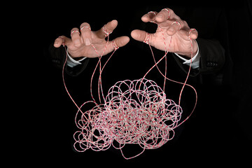 Hands pulling tangled strings. Concept of emotional manipulation, mental health, world conspiracy...