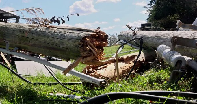 When strong winds occurred during hurricane, electric poles with broken wires crashed to ground