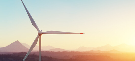 Wind turbine in mountain landscape during sunset