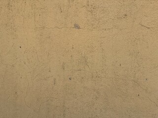 Texture of old rustic wall covered with yellow stucco. Abstract background for design.