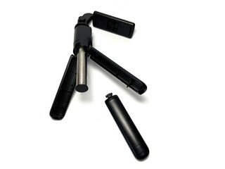 Broken small mobile phone tripod isolated on white background with clipping path. Studio shot.