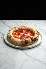 Pepperoni pizza with salami sausage and cheese on a white plate