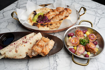 Chicken lula kebab with vegetables and pita bread