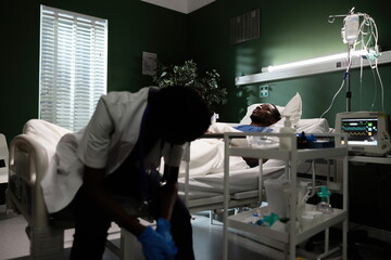 In this scene, a doctor provides a reassuring presence by the side of an unconscious patient.