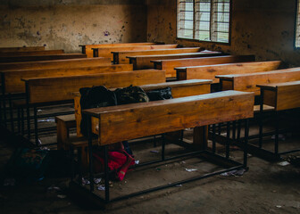 a classroom with a wooden ceiling and a window with a wooden desk inside