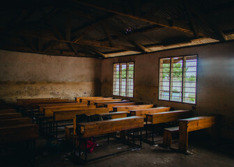 a classroom with a wooden ceiling and a window with a wooden desk inside