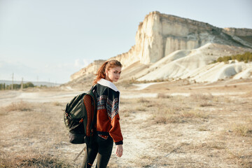 solitary traveler pauses to admire desert landscape with majestic mountains in the distance