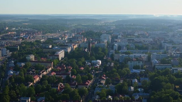 Aerial view captures the city of Turku, Finland, showcasing the vibrant cityscape and the Hauraki river in the background on a sunny summer day