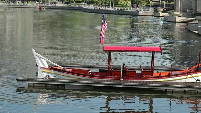 Putra Jaya, Malaysia on May 22, 2023. A small boat owned by Cruise Tasik Putra Jaya. Set sail with us and enjoy the magnificent view that includes the iconic Putra Mosque, Seri Wawasan Bridge and Perd