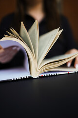 Artistic concept with open book pages on wooden surface, symbolizing literature and academia