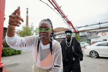 Duo expressing vibrant urban street culture with energetic gestures and confident attitudes in...