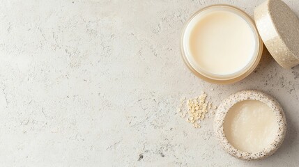 Exfoliating scrub with natural ingredients on a textured stone surface, small grains and smooth cream visible