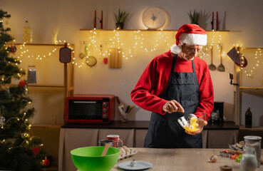 Christmas and New Year celebration traditions. Elderly man cooking dough for ginger cookies. Family home bakery and cooking festive sweets.