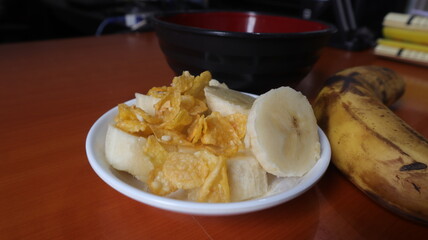 wheat cereal and banana fruit on wooden table