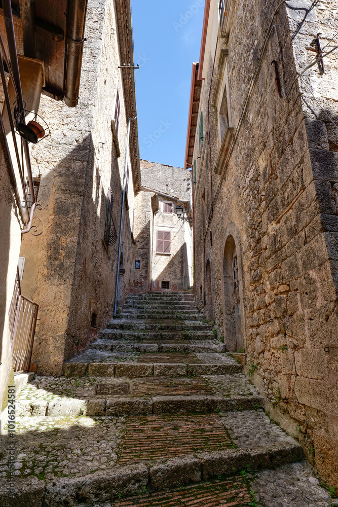 Poster A street between the old houses of Casalvieri in Lazio, Italy.