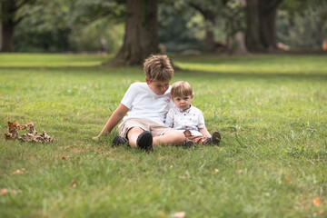 Fototapeta premium Brothers, Happy young brothers walking at the park. Friendship brotherhood concept