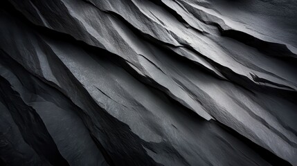 Fototapeta premium An abstract image featuring sharp contrasts and geometric designs of layered stones, providing an intense and dynamic visual experience against a stark backdrop.