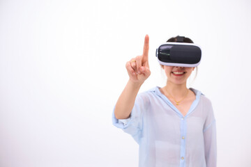 Asian woman using remote VR virtual reality headset augmented playing gaming reality simulation, finger touching waving hands simulating interacting virtual world with white background copyspace.