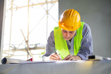 Caucasian man architect engineer construction working on blueprint design plan using compass...