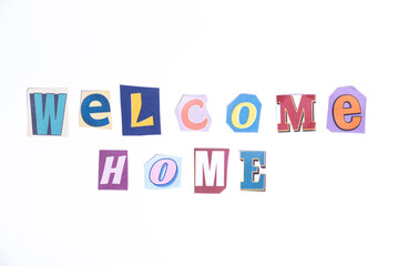 Welcome symbol. Concept words Welcome Home isolated on clean white background in fun cut out newspaper style typescript. 