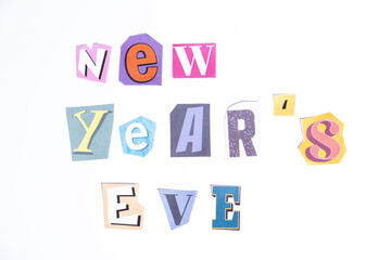 Phrase New Year's Eve spelled in cut out newspaper style typography isolated on white background.