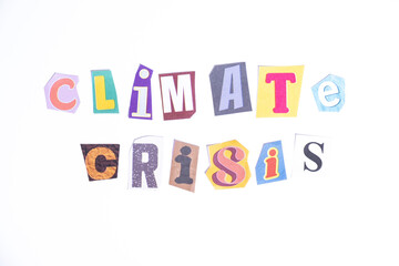Phrase Climate Crisis spelled in cut out newspaper style typography isolated on white background.