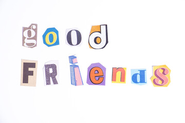 Phrase Good Friends spelled in cut out newspaper style typography isolated on white background.
