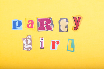 Obraz premium Phrase Party Girl spelled in cut out newspaper style typography, isolated on yellow background.