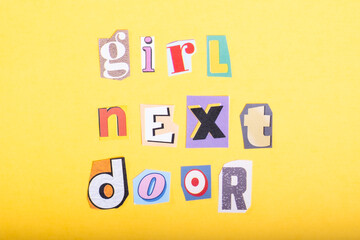 Phrase Girl Next Door spelled in cut out newspaper style typography, isolated on yellow background.