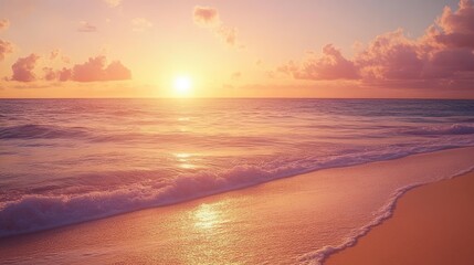 Obraz premium A serene sunset beach scene with calm waves gently touching the golden sand, and the sky glowing in shades of pink and orange, ideal for vacation imagery