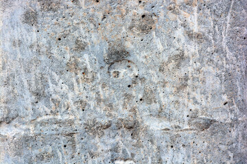 Original background, building materials, gray cement walls covered with light brush strokes with white paint.