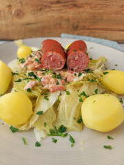 Plate of Savoy Cabbage, Boiled Potatoes, and German Smoked Sausage with Creamy Bacon Sauce