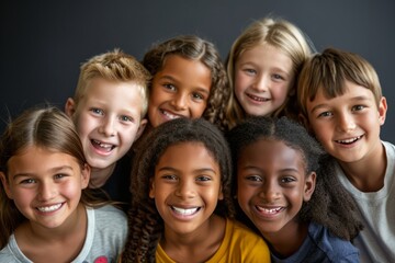 Group of happy children smiling and looking at camera over grey background.