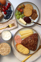 Assortment of various breakfast foods and drinks on the white table. Flat lay.