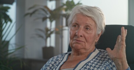 Elderly woman with graying hair talks about mental disorder and consequences of psychological trauma. Female patient shares experiences and fears. Treatment of mental disorders. Close up. Portrait.