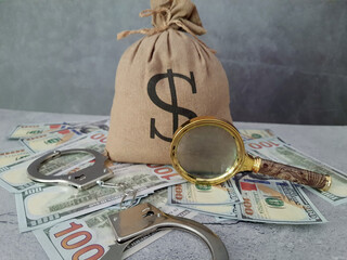Bag of money, magnifying glass, and handcuffs.